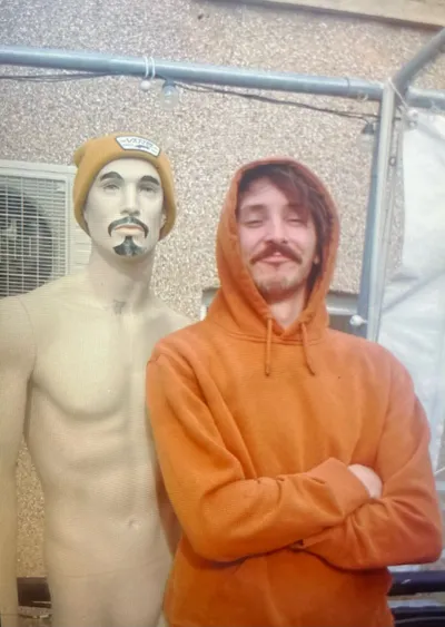 Person posing with mannequin outdoors