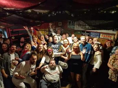 Large group celebrating inside pub